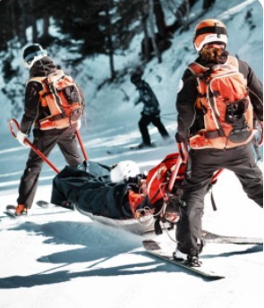 ski patrol carrying patient down mountain